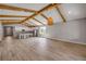 Bright open living room with wood-look floors, beam ceilings and a view of the kitchen at 1100 Loch Linnhe Ct, New Smyrna Beach, FL 32168