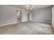 Living room featuring access to a bathroom, with a plush carpet at 1100 Loch Linnhe Ct, New Smyrna Beach, FL 32168
