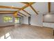 Inviting living room with beam ceilings, wood-look tile floors, and an open layout at 1100 Loch Linnhe Ct, New Smyrna Beach, FL 32168