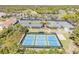 Aerial view showcasing community tennis courts with multiple playing options at 1100 Loch Linnhe Ct, New Smyrna Beach, FL 32168