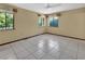 A bright bedroom with tile floors, natural lighting from two windows, and ceiling fan at 1105 Burgoyne Rd, Deland, FL 32720
