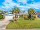 Charming single-story home featuring a well-manicured lawn and tasteful landscaping at 124 Anchor Dr, Ponce Inlet, FL 32127