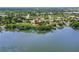 Stunning aerial view of lakefront home surrounded by mature trees and lush landscaping at 1364 W Hartley Cir, Deltona, FL 32725