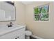 Bright bathroom features a modern vanity, sleek fixtures, and a window providing natural light at 1364 W Hartley Cir, Deltona, FL 32725