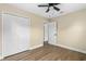 Bedroom featuring a ceiling fan, new vinyl floors, and a closet at 1364 W Hartley Cir, Deltona, FL 32725