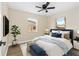 Comfortable bedroom featuring a ceiling fan, hardwood floors, two windows, a neutral wall color, and stylish decor at 1364 W Hartley Cir, Deltona, FL 32725