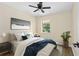 Comfortable bedroom featuring a ceiling fan, hardwood floors, a window, a neutral wall color, and stylish decor at 1364 W Hartley Cir, Deltona, FL 32725