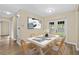 Bright dining room featuring modern decor, wood floors, and natural light from the double doors to the backyard at 1364 W Hartley Cir, Deltona, FL 32725
