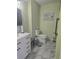 Stylish bathroom with a modern vanity, marble floors, and a wall mounted handrail at 2530 Tamarind Dr, Edgewater, FL 32141