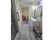 Modern bathroom features marble floors, a stylish vanity, and a seamless glass shower door at 2530 Tamarind Dr, Edgewater, FL 32141