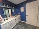 Bathroom featuring double sinks with marble countertop, tiled floors, and a mirror at 2530 Tamarind Dr, Edgewater, FL 32141
