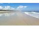 Expansive beach with gentle waves, perfect for leisurely strolls along the shore at 2530 Tamarind Dr, Edgewater, FL 32141