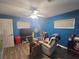 Relaxing bedroom featuring blue walls, ceiling fan, and comfortable chair at 2530 Tamarind Dr, Edgewater, FL 32141