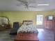 Relaxing bedroom features natural light, a ceiling fan, and hardwood flooring at 2530 Tamarind Dr, Edgewater, FL 32141