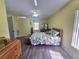 Spacious bedroom with hardwood floors, a ceiling fan, and a window with lots of natural light at 2530 Tamarind Dr, Edgewater, FL 32141