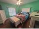 Bright bedroom with hardwood floors, a ceiling fan, and a double hung window at 2530 Tamarind Dr, Edgewater, FL 32141
