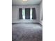 Bedroom featuring 3 large windows with curtains and neutral walls and carpeting at 2797 Nordman Ave, New Smyrna Beach, FL 32168