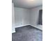 Neutral bedroom features gray walls and carpeting and window with coverings at 2797 Nordman Ave, New Smyrna Beach, FL 32168