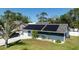 Charming home with a two-car garage, solar panels, lush landscaping, and manicured lawn at 2797 Nordman Ave, New Smyrna Beach, FL 32168