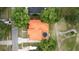 This home features a unique red roof, a pool, and mature landscaping at 2813 Ballard Ave, Orlando, FL 32833