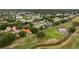Breathtaking aerial view of a residential area with a golf course and serene pond at 2813 Ballard Ave, Orlando, FL 32833