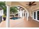 Covered back patio with white columns and view of the pool, outdoor kitchen, and backyard, creating an inviting outdoor space at 2813 Ballard Ave, Orlando, FL 32833