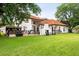 Expansive backyard with pool, outdoor kitchen, and a large grassy area ideal for recreation at 2813 Ballard Ave, Orlando, FL 32833