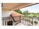 Balcony overlooking a lush landscape, featuring wrought iron railings and a tiled roof at 2813 Ballard Ave, Orlando, FL 32833