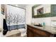Bathroom with granite countertop, wood cabinet, decorative mirror, and decorative shower curtain at 2813 Ballard Ave, Orlando, FL 32833