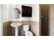 Half bath featuring decorative tile, pedestal sink, and medicine cabinet at 2813 Ballard Ave, Orlando, FL 32833