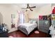 Cozy bedroom featuring hardwood floors, a ceiling fan, and a large dresser at 2813 Ballard Ave, Orlando, FL 32833