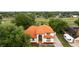 This front exterior features a unique red tile roof and is situated in a lush landscape at 2813 Ballard Ave, Orlando, FL 32833