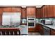 Well-equipped kitchen boasts stainless steel appliances, dark wood cabinets, and granite countertops at 2813 Ballard Ave, Orlando, FL 32833
