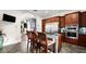 Well-equipped kitchen boasts stainless steel appliances, dark wood cabinets, granite counters, and central island with bar seating at 2813 Ballard Ave, Orlando, FL 32833