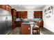 Gourmet kitchen with stainless steel appliances, granite countertops, custom cabinets, and a breakfast bar at 2813 Ballard Ave, Orlando, FL 32833
