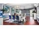 Bright living space showcasing hardwood floors, colorful artwork, contemporary lighting, and comfortable gray seating at 2813 Ballard Ave, Orlando, FL 32833