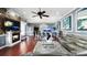 Open-concept living room featuring hardwood floors, a modern fireplace, and contemporary decor and furnishings at 2813 Ballard Ave, Orlando, FL 32833