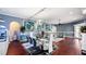 Spacious living room with modern decor, colorful artwork, hardwood flooring, and a wall-mounted fish tank at 2813 Ballard Ave, Orlando, FL 32833