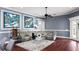 Comfortable living room with plush seating, a modern ceiling fan, stylish decor, and bright, airy feel at 2813 Ballard Ave, Orlando, FL 32833