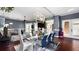 Open living and dining area featuring a modern light fixture, fireplace, hardwood floors, and comfortable seating at 2813 Ballard Ave, Orlando, FL 32833