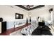 Spacious main bedroom with tray ceiling, fan, hardwood floors, walkout access, and black-and-white decor at 2813 Ballard Ave, Orlando, FL 32833