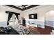 Spacious main bedroom with tray ceiling, fan, hardwood floors, walkout access, and black-and-white decor at 2813 Ballard Ave, Orlando, FL 32833