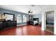 Large bedroom with unique windows, red hardwood floors, fan, and a black dresser at 2813 Ballard Ave, Orlando, FL 32833
