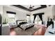 Spacious main bedroom with tray ceiling, fan, hardwood floors, walkout access, and black-and-white decor at 2813 Ballard Ave, Orlando, FL 32833