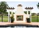 Inviting outdoor fireplace with decorative columns and planters next to a pool at 2813 Ballard Ave, Orlando, FL 32833