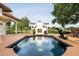 Relaxing pool area featuring a decorative fountain, outdoor fireplace, and a spacious deck for lounging at 2813 Ballard Ave, Orlando, FL 32833