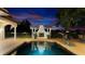 This pool features a small fountain, with an outdoor fireplace in the background at 2813 Ballard Ave, Orlando, FL 32833