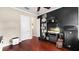 Room with dark walls, hard wood floors, shelves, and two doors at 2813 Ballard Ave, Orlando, FL 32833