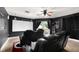 Home theater featuring black leather seating, a projector screen, and dimmable lighting at 2813 Ballard Ave, Orlando, FL 32833