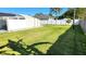 Expansive backyard with a white fence, mature trees, and manicured lawn, perfect for outdoor activities at 2820 Tamarind Dr, Edgewater, FL 32141
